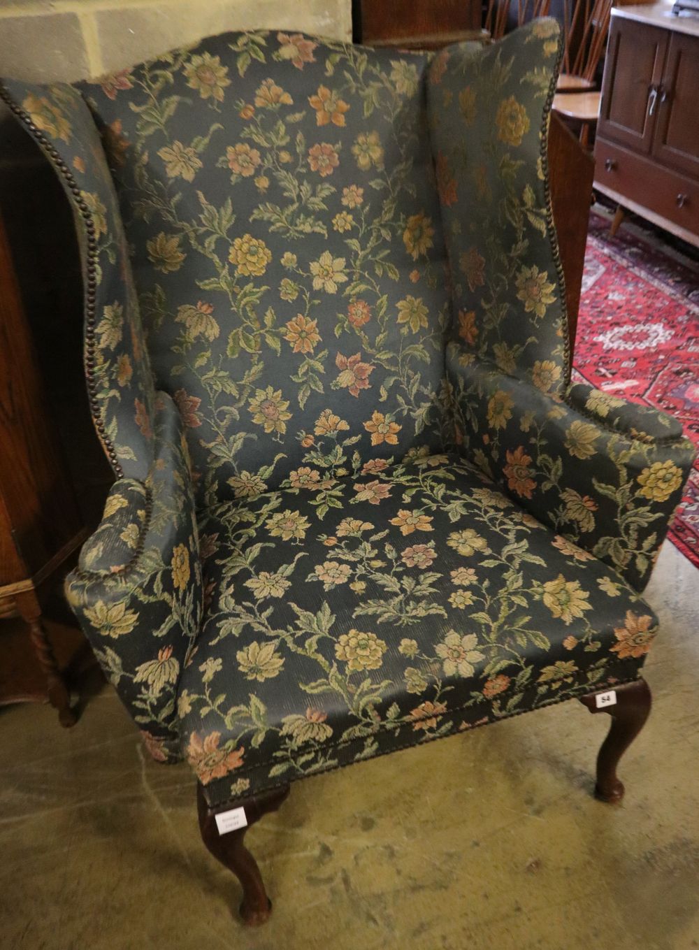 A George I style mahogany framed wing armchair